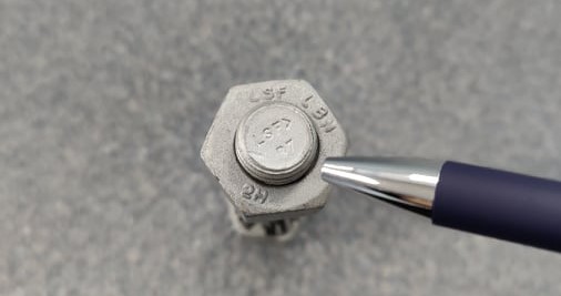 The identifiable markings at the end of a bolt. Identifiable markings are important for ASME compliance.